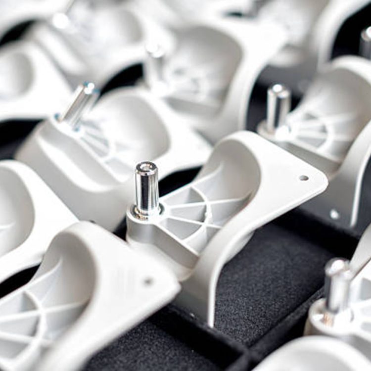 Horizontal color image of plastic parts of wheels for suitcases and chairs. Production line in large factory, production of plastic goods.